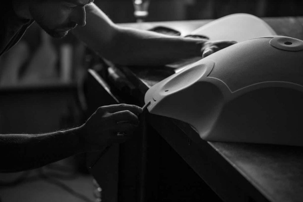 A shaper sanding a new climbing hold shape