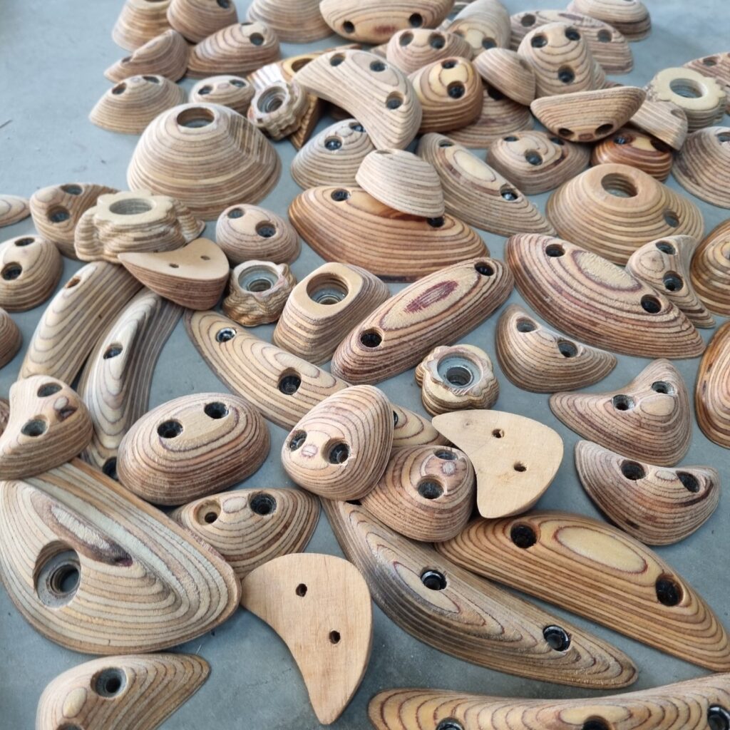 Druid Holds 16 A pile of raw wooden climbing holds by Druid Holds