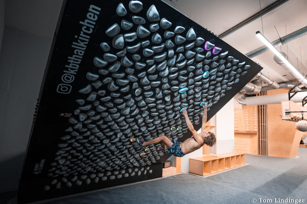 Climber on a Kilter Board home wall