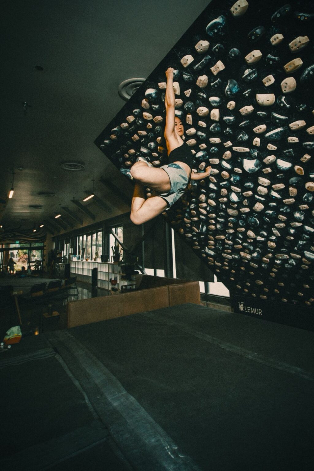 Climber on a Lemur Design adjustable LED board in a training room