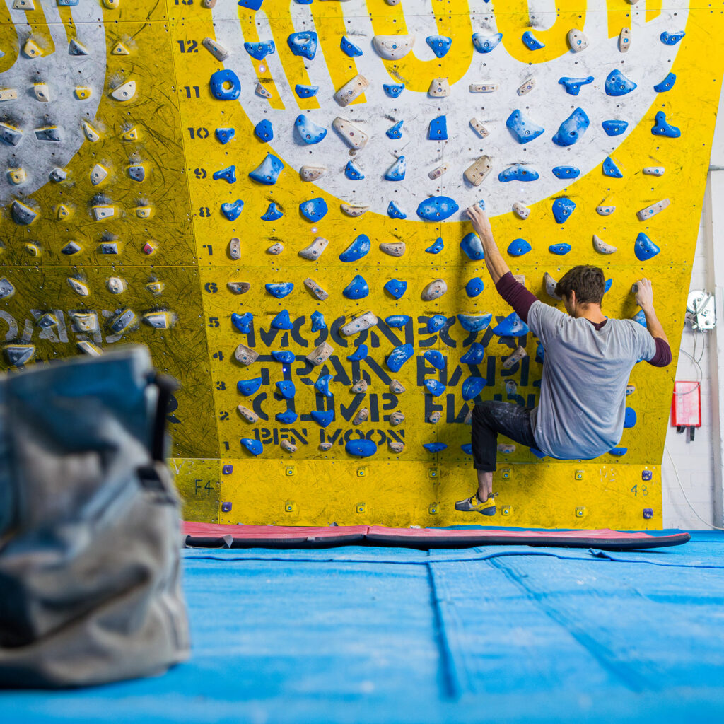 Climber training on a MoonBoard 2024 setup